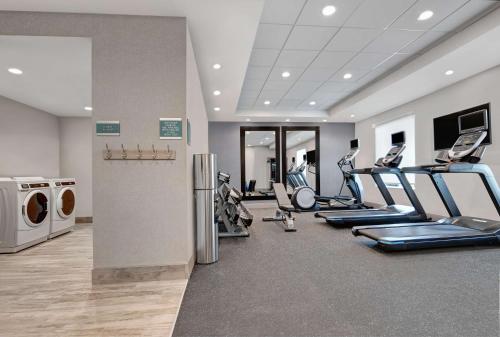 a gym with treadmills and elliptical machines at Home2 Suites By Hilton Bentonville Rogers in Bentonville