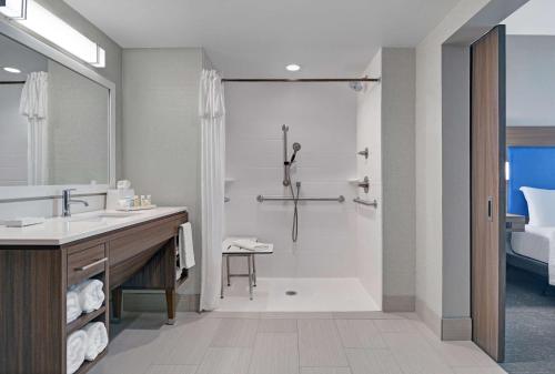a bathroom with a shower and a sink at Home2 Suites By Hilton Bentonville Rogers in Bentonville