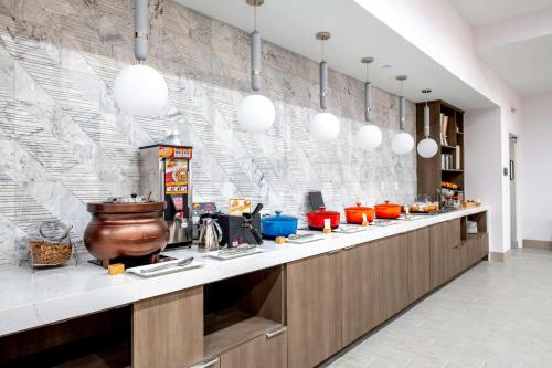 a kitchen with a long counter with a counter top at Doubletree Sulphur Lake Charles in Sulphur