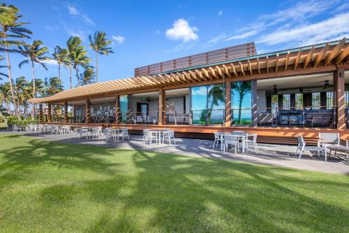 a building with chairs and tables on a lawn at Hilton Grand Vacations Club Maui Bay Villas in Kihei