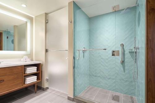 a bathroom with a shower with a glass door at Hilton Grand Vacations Club Maui Bay Villas in Kihei