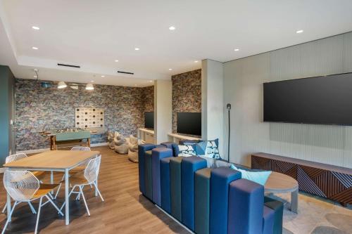 a waiting room with a table and chairs and a tv at Hilton Grand Vacations Club Maui Bay Villas in Kihei