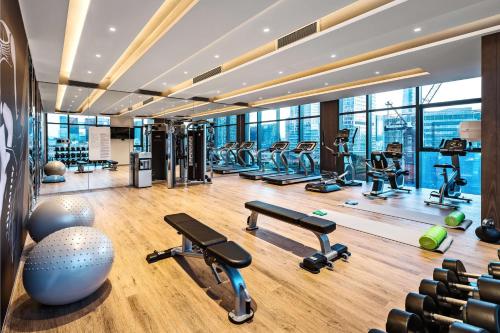 a gym with treadmills and exercise equipment in a building at The Mercury Garden Shenzhen Nanshan, A Tribute Portfolio Hotel in Shenzhen