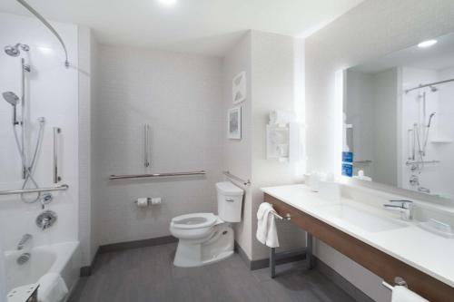 a white bathroom with a toilet and a sink at Hampton Inn Greer Greenville, Sc in Greer