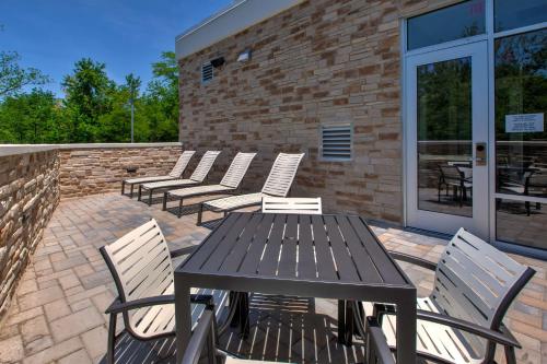 a wooden table and chairs on a patio at Homewood Suites By Hilton Columbus Easton, Oh in Columbus