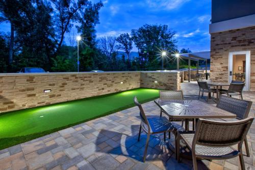 a patio with a green pool in a backyard at Homewood Suites By Hilton Columbus Easton, Oh in Columbus