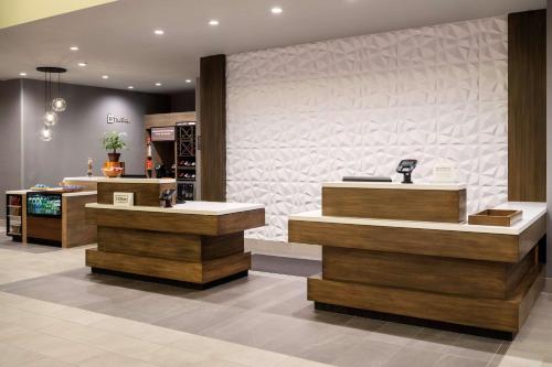 a hair salon with wooden counters and a wall at Hilton Garden Inn Chino Hills Pomona CA in Pomona