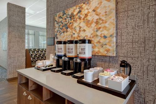 a counter with a bunch of bottles of wine on it at Hampton Inn & Suites Sunnyvale-Silicon Valley, Ca in Sunnyvale