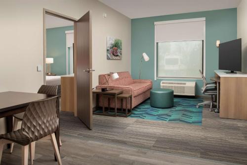a hotel room with a desk and a chair at Home2 Suites By Hilton Kenner New Orleans Arpt in Kenner