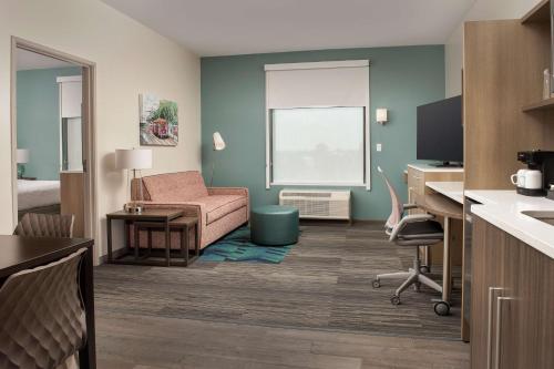 a living room with a couch and a chair in a room at Home2 Suites By Hilton Kenner New Orleans Arpt in Kenner