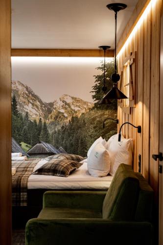 a bedroom with a bed with a picture of a mountain at Ku Dolinie in Kościelisko