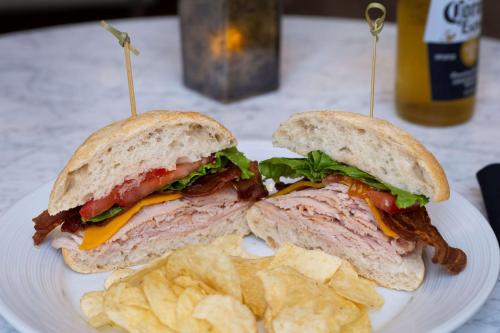 a sandwich and chips on a white plate at Hilton Richardson Dallas, TX in Richardson