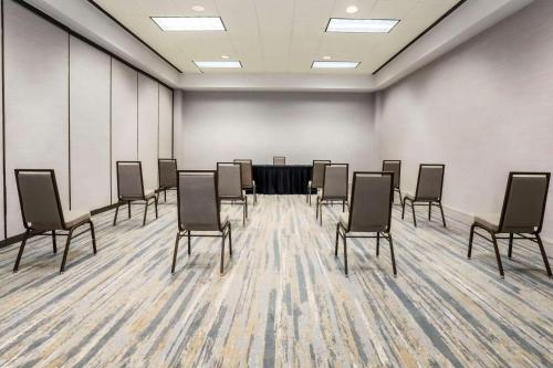 a conference room with a table and chairs in it at Hilton Richardson Dallas, TX in Richardson