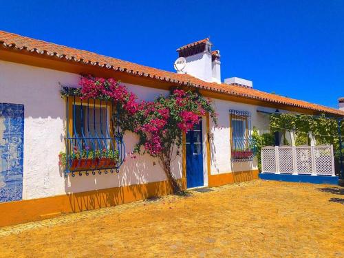 a house with flowers on the side of it at Herdade das Coutadas by Portus Alacer in Portalegre