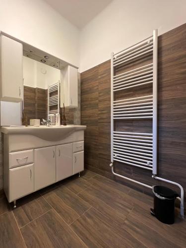 a bathroom with a sink and a mirror at AranyLak vendégház in Abádszalók