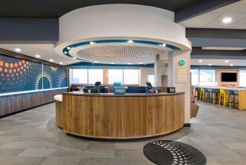 a lobby with a reception desk in a hospital at Tru By Hilton Ashburn One Loudoun, Va in Ashburn
