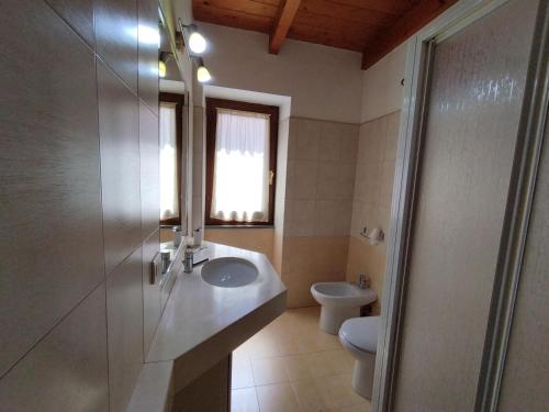 a bathroom with a sink and a toilet at CARRELA 'E BRETA in Thiesi
