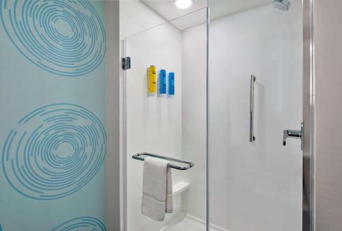 a bathroom with a shower with a glass door at Tru By Hilton Ashburn One Loudoun, Va in Ashburn