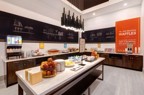 a breakfast counter in a restaurant with fruit on it at Hampton Inn & Suites Burlington, Ontario, Canada in Burlington