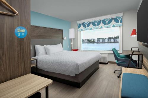 a hotel room with a bed and a window at Home2 Suites By Hilton Miami Airport South Blue Lagoon in Miami