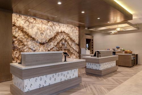 a lobby of a salon with a wall mural at Hilton Garden Inn Temecula in Temecula