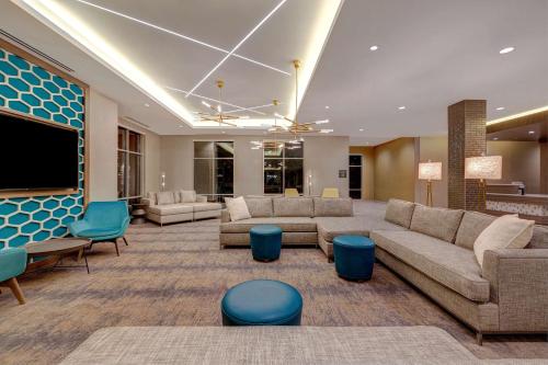 a large lobby with couches and a flat screen tv at Hilton Garden Inn Temecula in Temecula