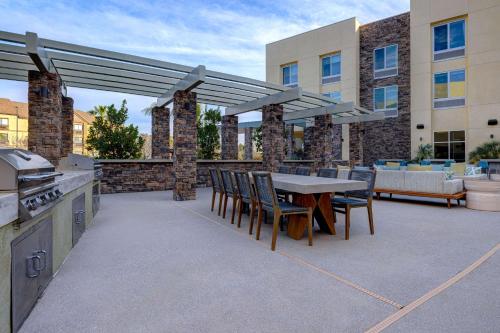 a patio with a table and chairs and a grill at Hilton Garden Inn Temecula in Temecula