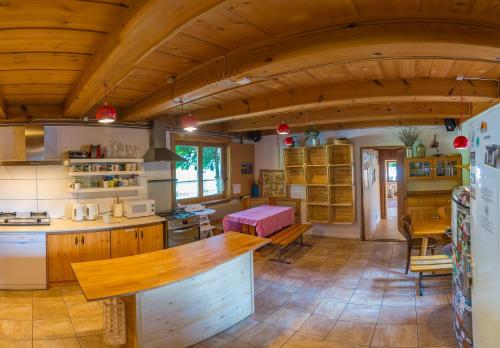 a large kitchen with a large wooden ceiling at Chata MTB in Kościelisko