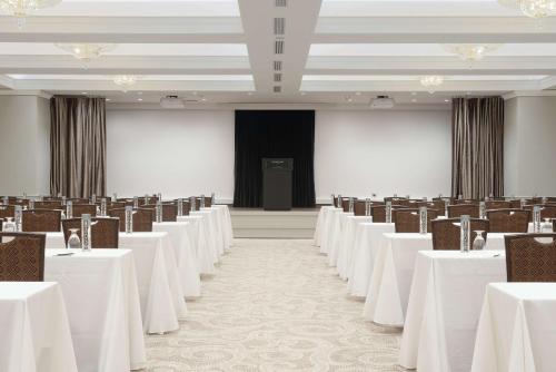 an empty banquet hall with tables and chairs at The Benson Portland, Curio Collection by Hilton in Portland