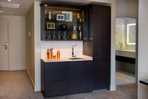 a kitchen with a counter with a sink in it at The Benson Portland, Curio Collection by Hilton in Portland