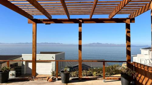 a view of the ocean from a pergola at Relax,Revive,Reset & enjoy the sounds of the sea! in Cape Town