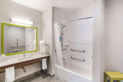 a bathroom with a tub and a sink and a shower at Hampton Inn & Suites Houghton in Houghton