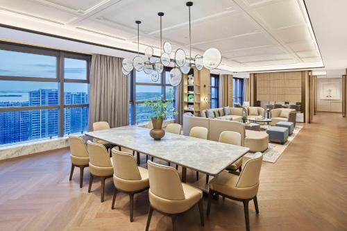 a dining room with a table and chairs at Hilton Suzhou Wuzhong in Suzhou