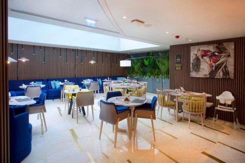 a dining room with tables and chairs in a restaurant at Hampton By Hilton Istanbul Old City in Istanbul