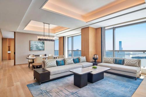 a living room with a couch and a dining room at Hilton Suzhou Wuzhong in Suzhou
