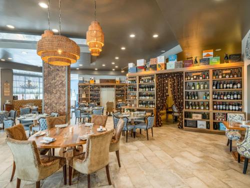 a restaurant with tables and chairs and bookshelves at Homewood Suites By Hilton Toledo Downtown in Toledo