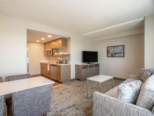 a living room with a couch and a kitchen at Homewood Suites By Hilton Toledo Downtown in Toledo