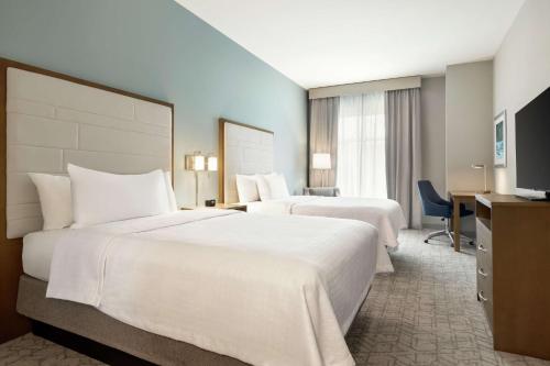 A bed or beds in a room at Homewood Suites By Hilton Mcdonough