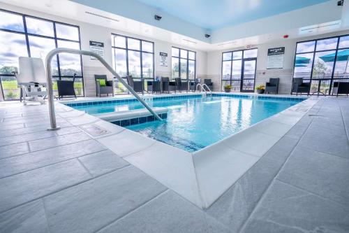 a pool in a building with a swimming pool at Hampton Inn By Hilton Huntley Chicago in Huntley