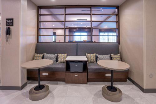 a waiting room with two tables and a couch at Hampton Inn By Hilton Huntley Chicago in Huntley