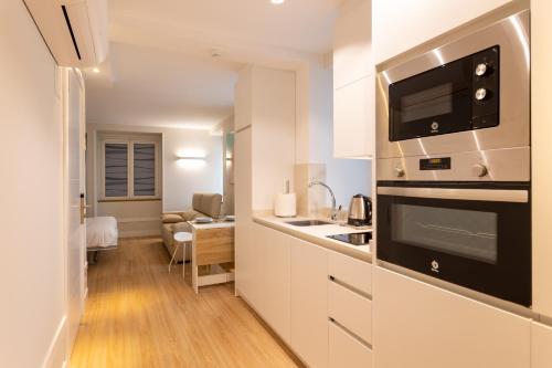 a kitchen with a sink and a stove top oven at Apartamentos&Spa Mundakaport in Mundaka