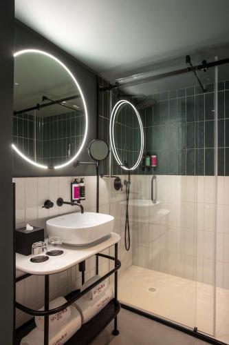 a bathroom with a sink and a shower at Se Catedral Hotel Porto, Tapestry Collection By Hilton in Porto