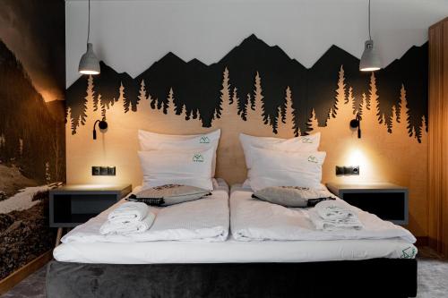 a bedroom with a bed with a mural of trees at Ku Dolinie in Kościelisko