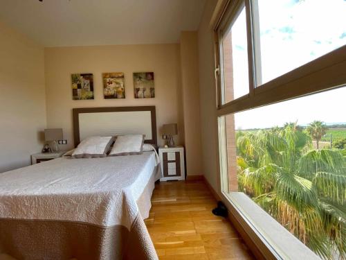 a bedroom with a bed and a large window at A&N Spacious Beach Apartment with Pool & Parking in Torre del Mar