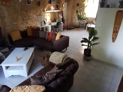 a living room with a couch and a table at Maison au Pied du Pont du Gard in Remoulins