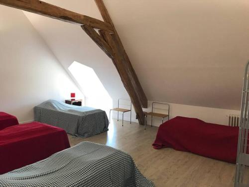 Zimmer im Dachgeschoss mit 2 Betten und 2 Stühlen in der Unterkunft Belle dépendance du château : LE LOGIS in Ardentes