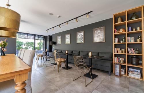 a living room with a couch and a table and chairs at Loft 1502 in Antalya