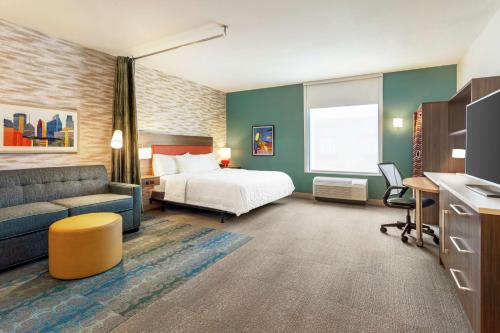 a hotel room with a bed and a couch at Home2 Suites By Hilton Minneapolis University Area in Minneapolis