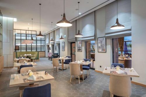 a dining room with tables and chairs and tablesktop at Hilton Garden Inn Erzurum in Erzurum