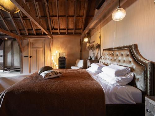 a bedroom with a large bed in a room at B&B Slapen bij DKW in Oldebroek
